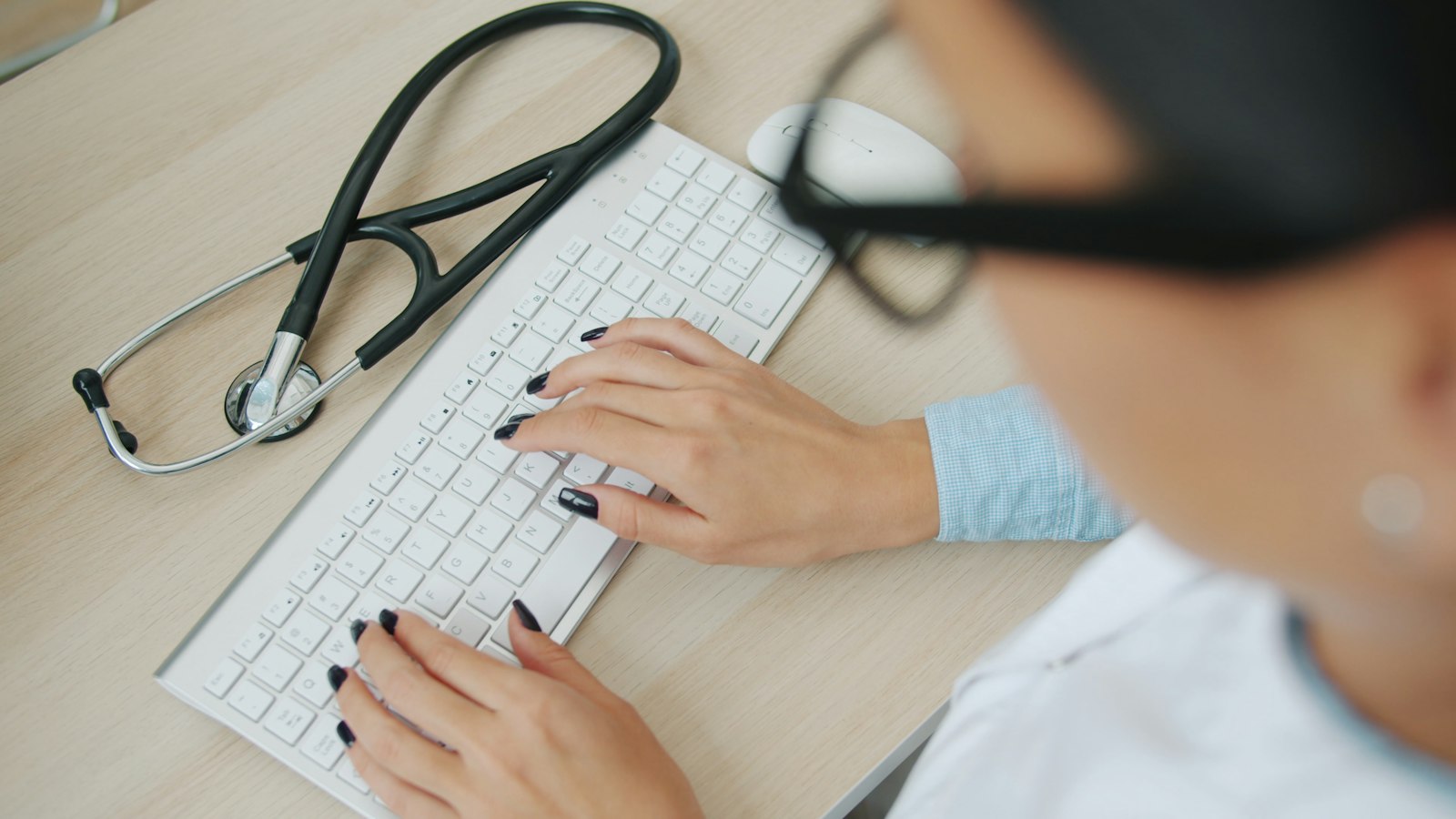 Medical billing specialist working at a computer